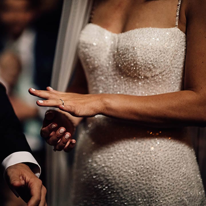 The bride looks at her new wedding ring 