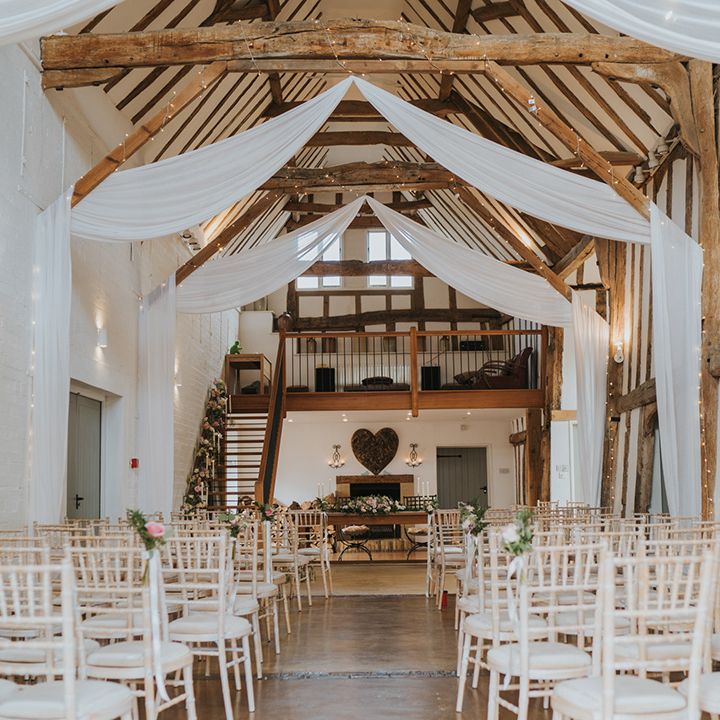 Dove Barn Weddings venue decorated with white drapes and fairy lights in Suffolk 
