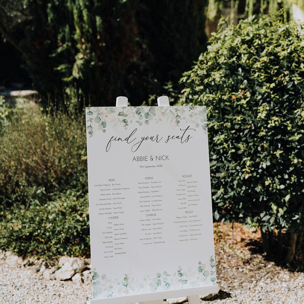 green and white seating chart on an easel 