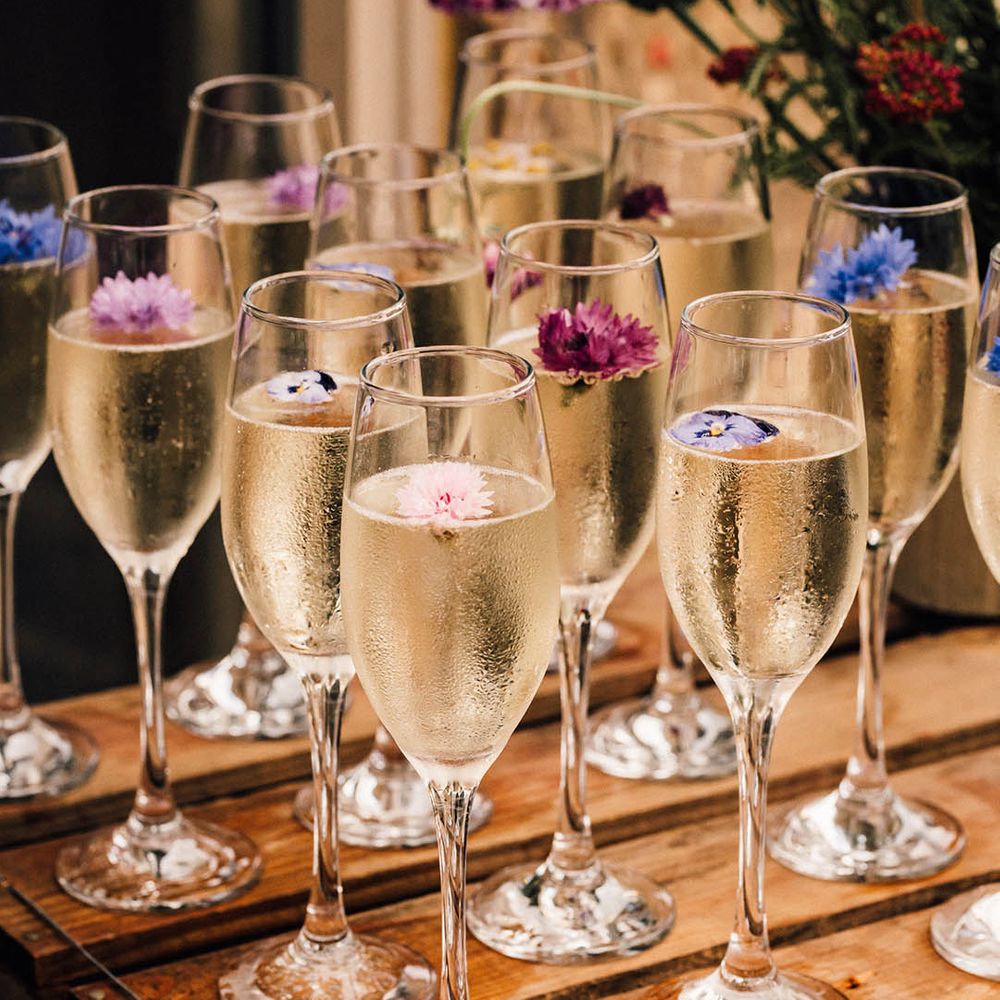 Edible flowers in glasses of champagne grown by the happy couple 