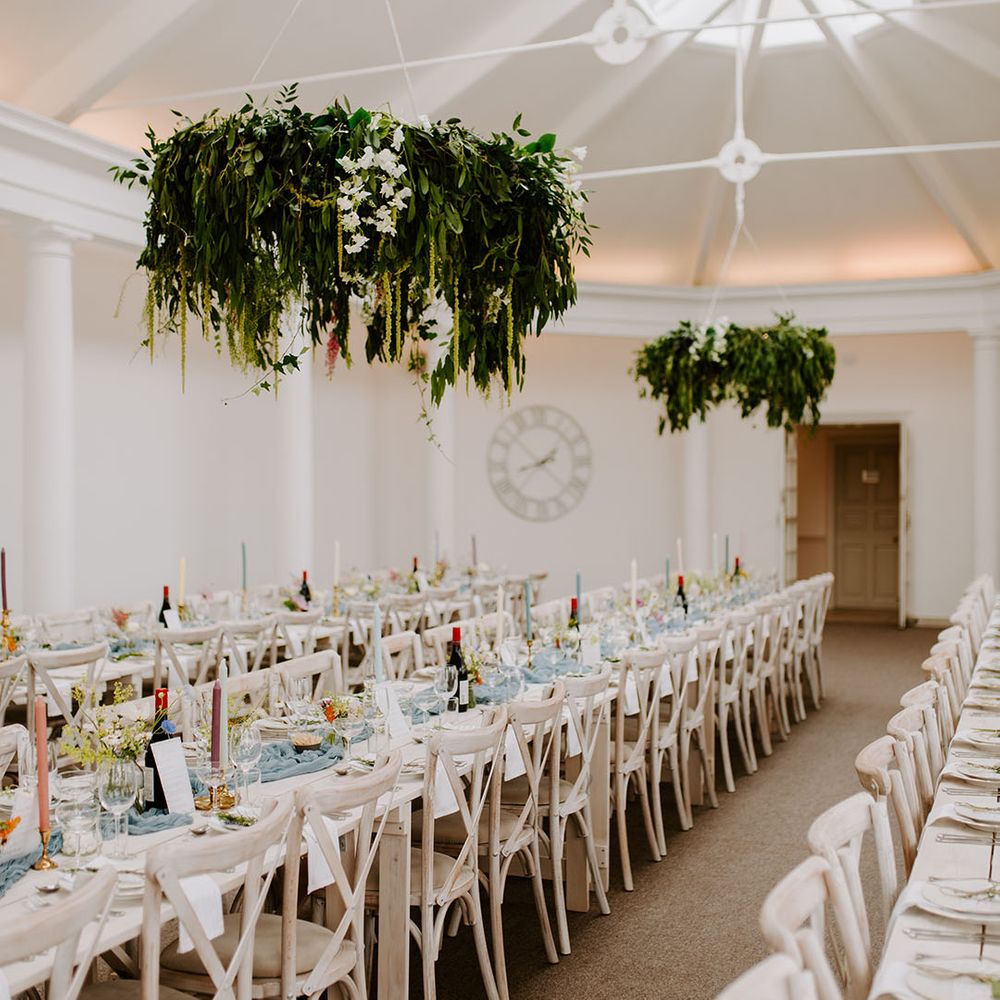 Pennsylvania Castle Estate wedding venue with long banquet tables and dusty blue decorations 