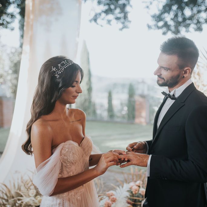 Bride and groom exchanging rings at Tuscany elopement 