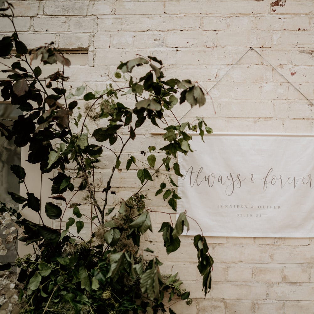 Always and forever fabric wedding sign hanging in the glasshouse reception 