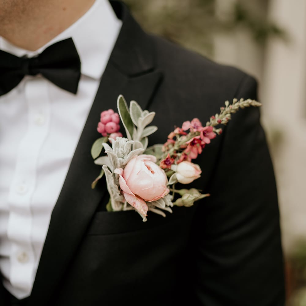 Pink and green grooms buttonhole 