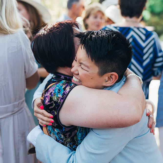 Bride hugs wedding guest on her wedding day