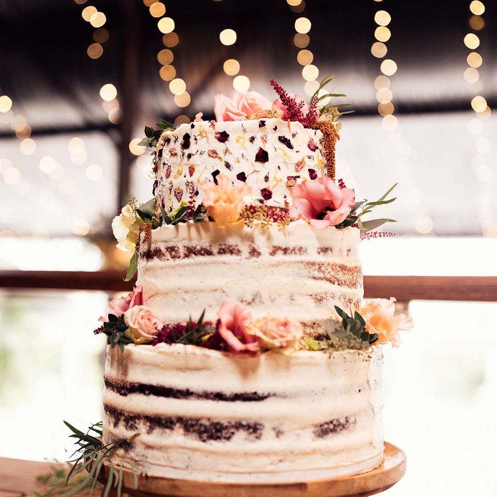 3 tier naked wedding cake complete with dried flowers and rustic vibe