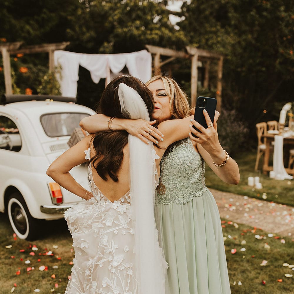 Bride hugs wedding guest on her wedding day