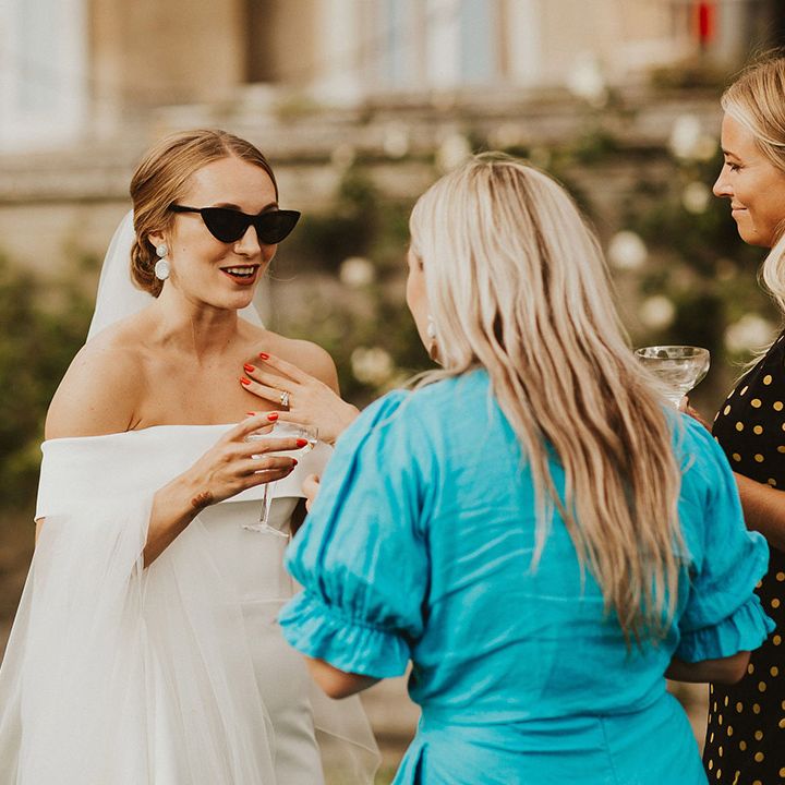Bride wears sunglasses outdoors on her wedding day