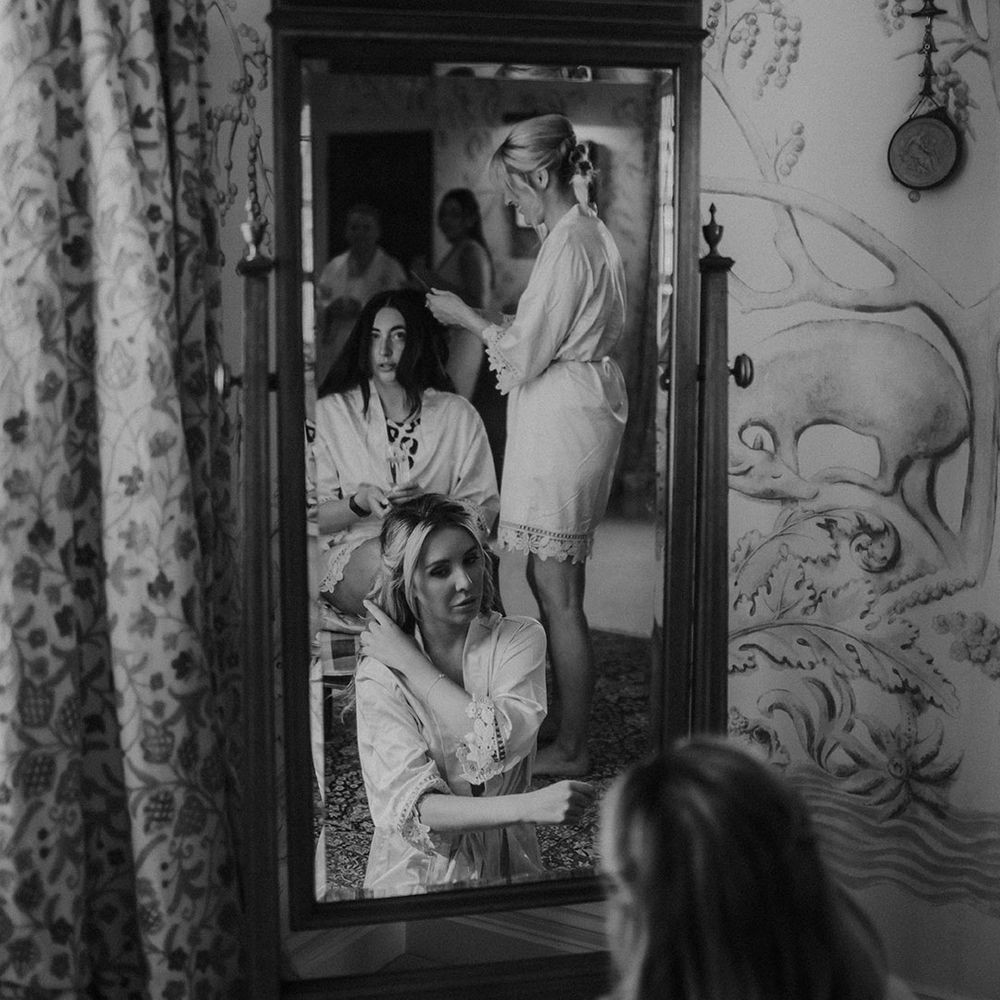 Bridal party in satin and lace getting ready robes on the morning of the wedding at Dewsall Court 