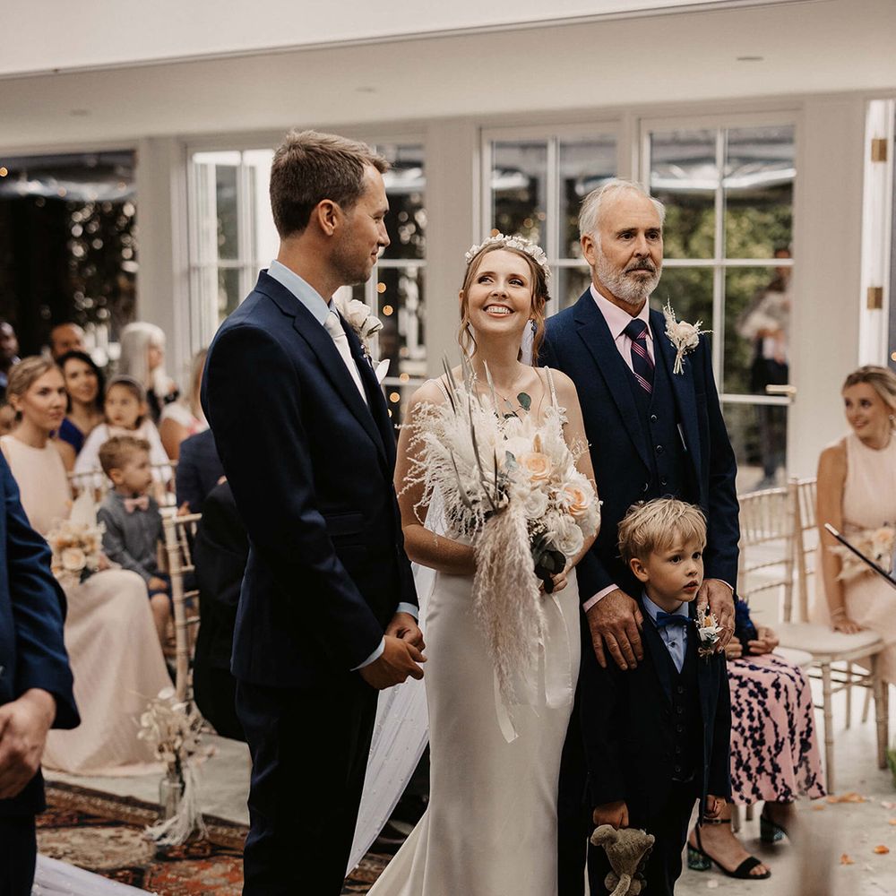 Bride looks lovingly at her husband during wedding ceremony
