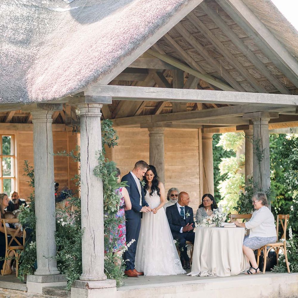 Bride & groom outdoors during their wedding ceremony at Euridge Manor
