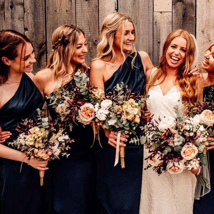 Bridal party holding reusable DIY artificial wedding bouquets