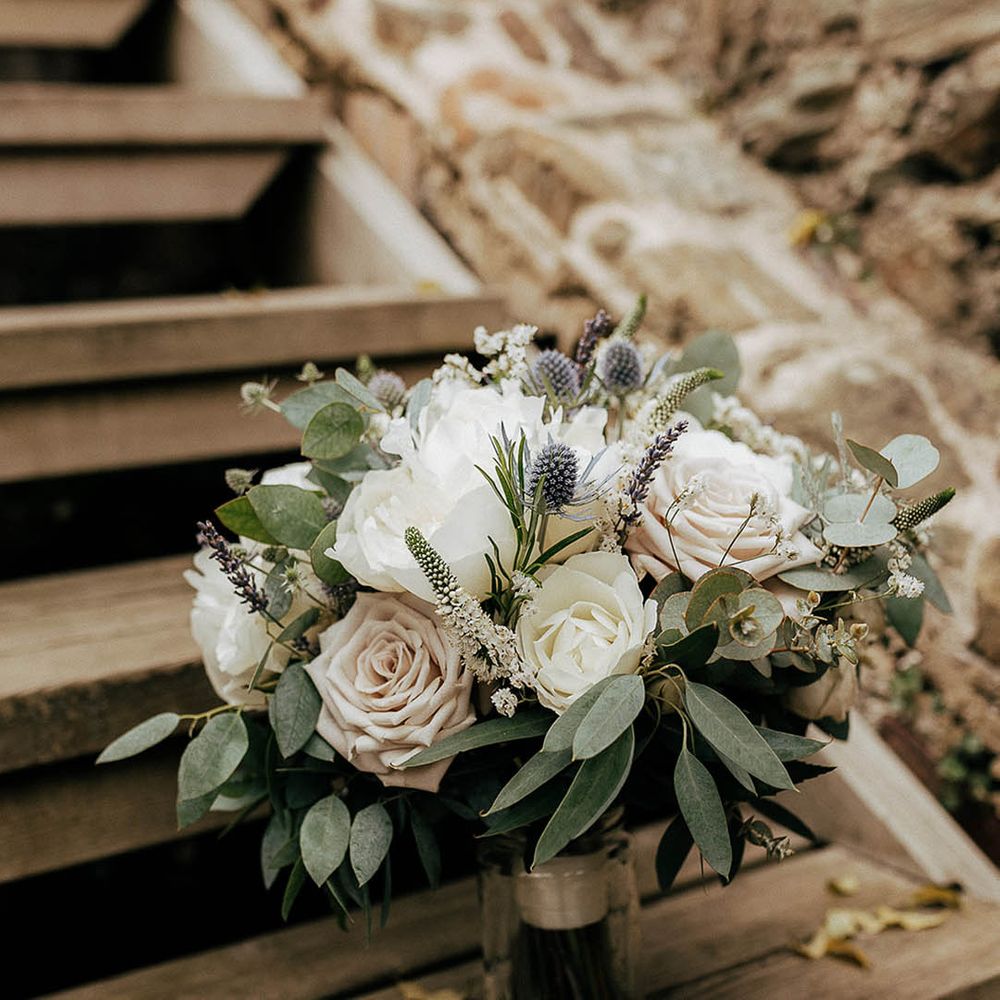 Pale pink and white roses complete with green foliage bridal bouquet 
