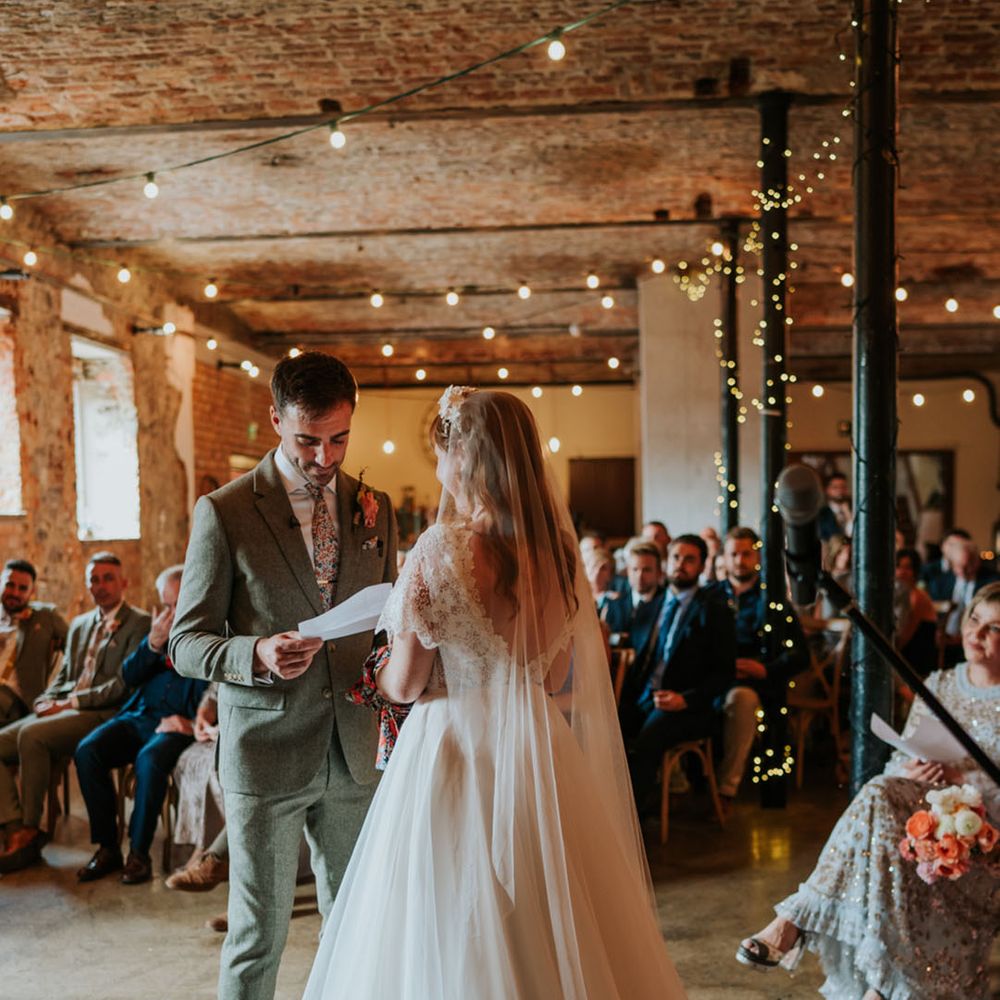Bride and groom participate in their wedding ceremony at The Wool Tower industrial style wedding venue 