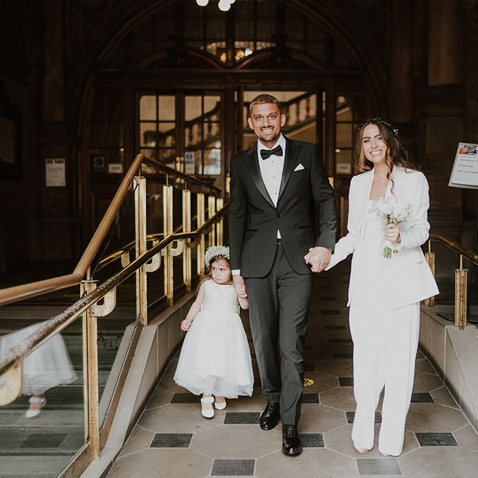 Intimate family wedding at Sheffield registry office with bride and groom in Reiss Suits with their daughter in a gypsophila flower crown 