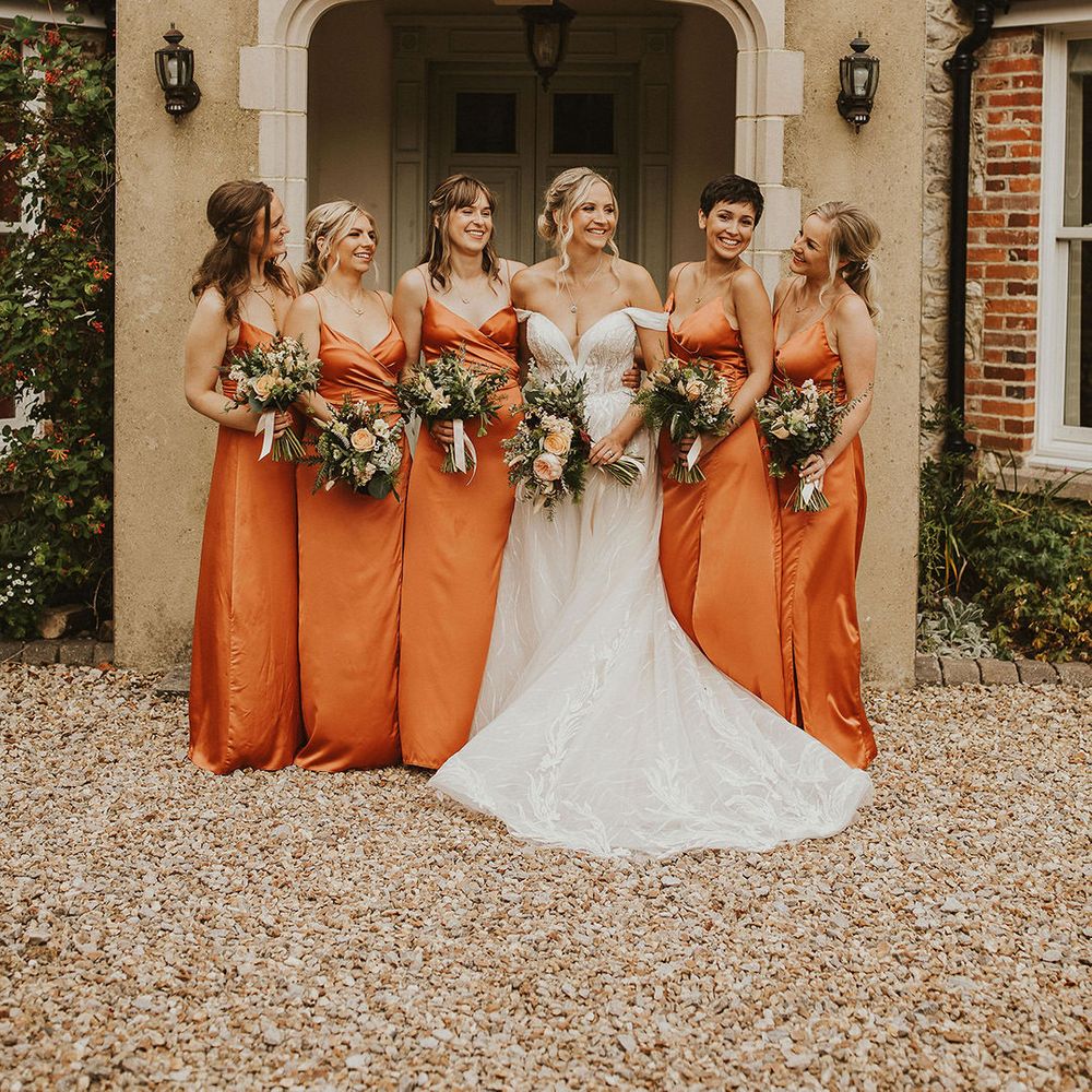 Orange bridesmaid dresses with bouquets