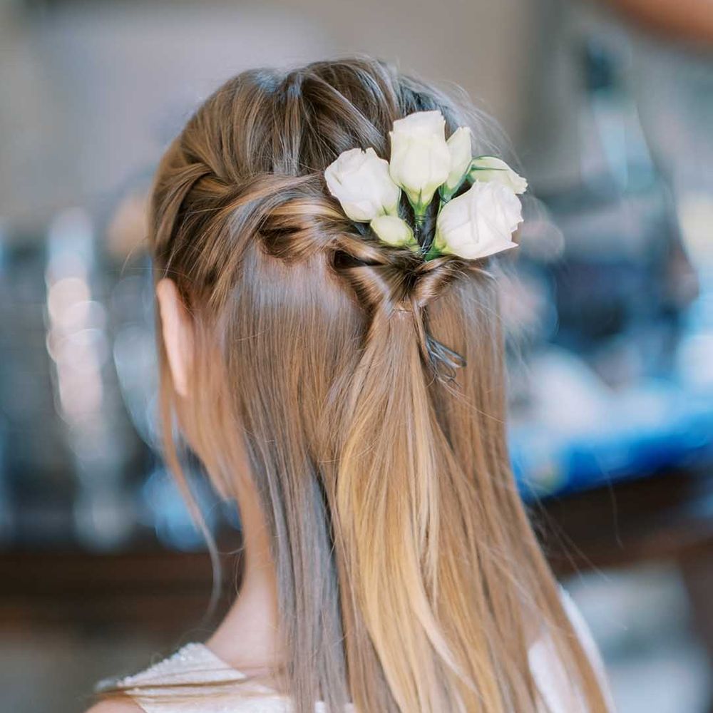 Flower girl with half up half down wedding hair and white roses 