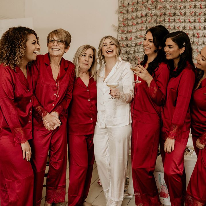 Bridal party in white and red satin pyjamas on the wedding morning 