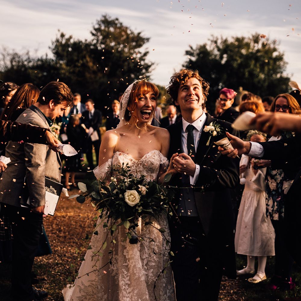 Confetti moment for bride and groom at Oxnead Hall venue in Norfolk