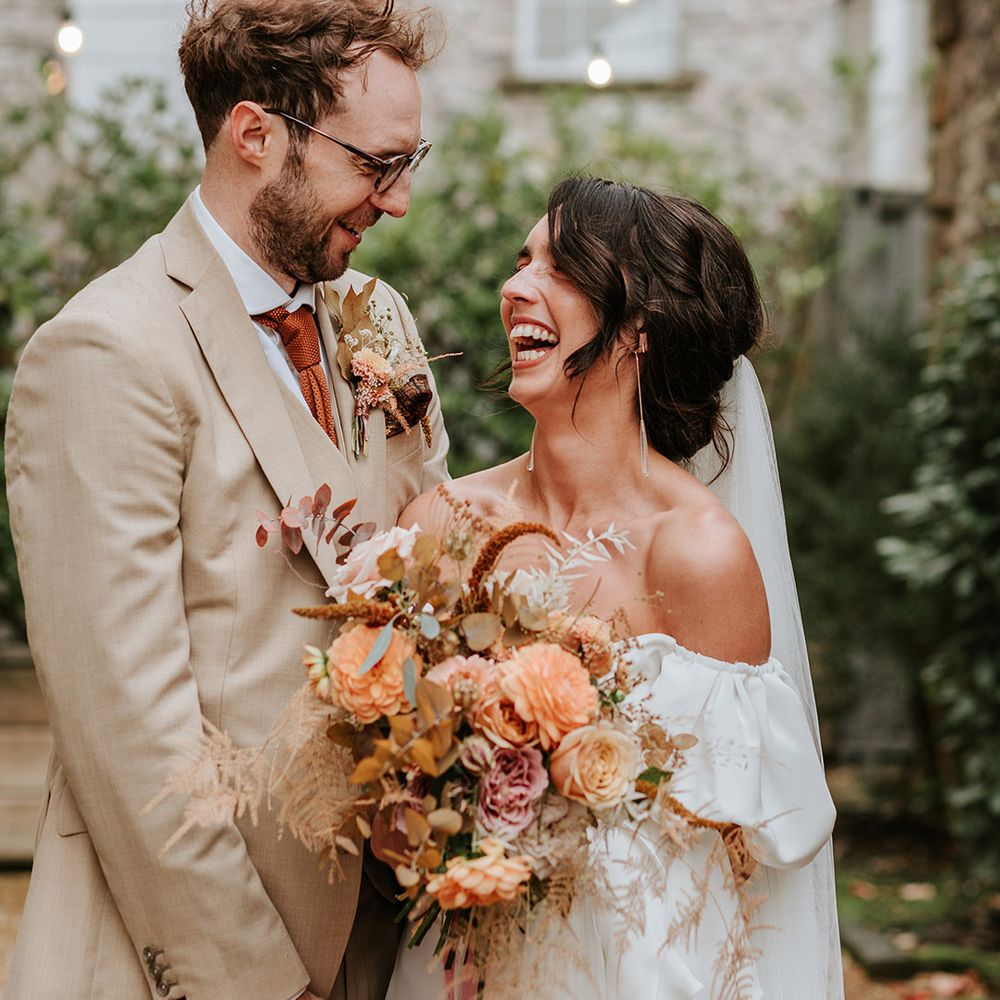 Bride and groom gaze into each other's eyes and smile after their wedding ceremony