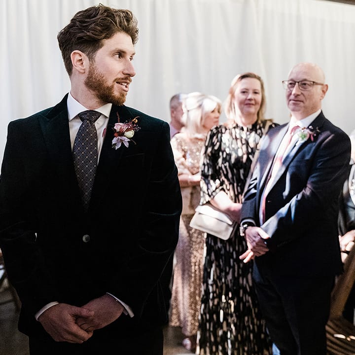 Groom turns to look at the bride for wedding ceremony