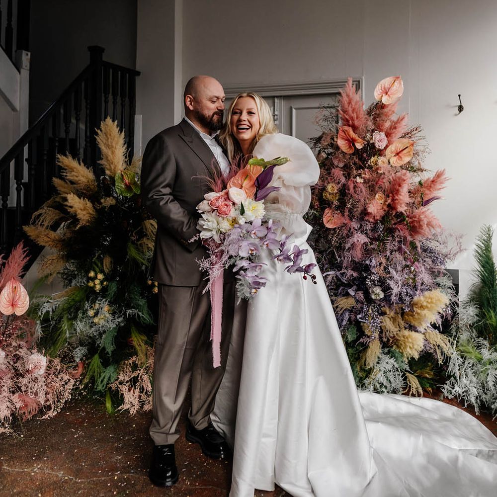 pink pampas grass, astilbe, and anthuriums column flower arrangements for modern stylish London wedding with bride in a princess wedding dress 