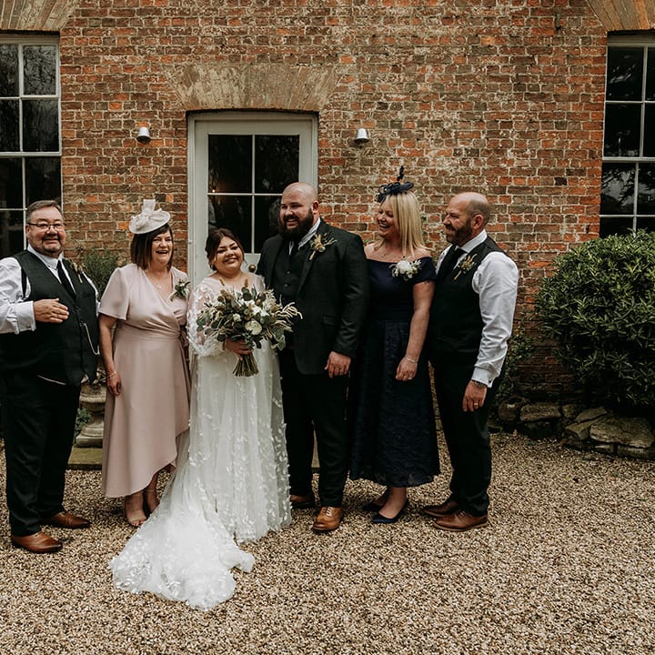 Bride and groom with their parents on their wedding day 