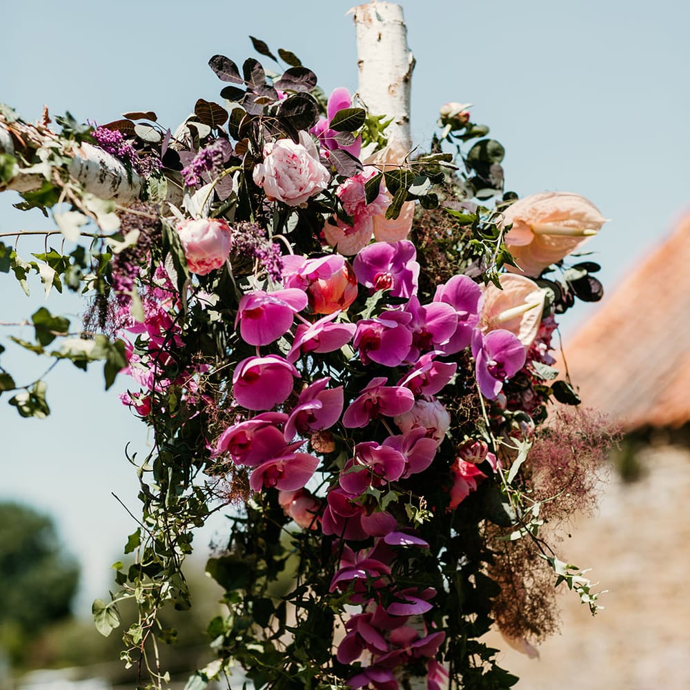 Wedding flower arrangement decorations with pink orchid wedding flowers, peonies and anthuriums 