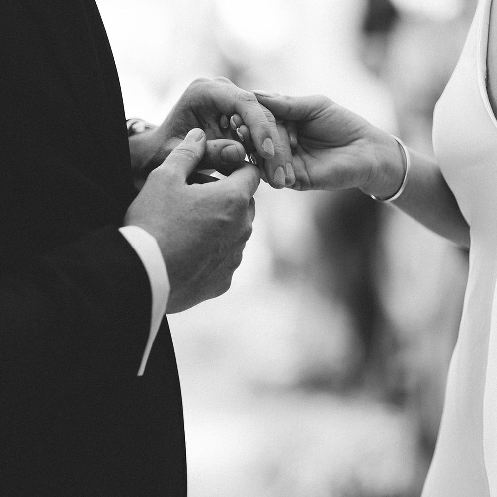 Groom puts on bride's wedding ring during the wedding ceremony 