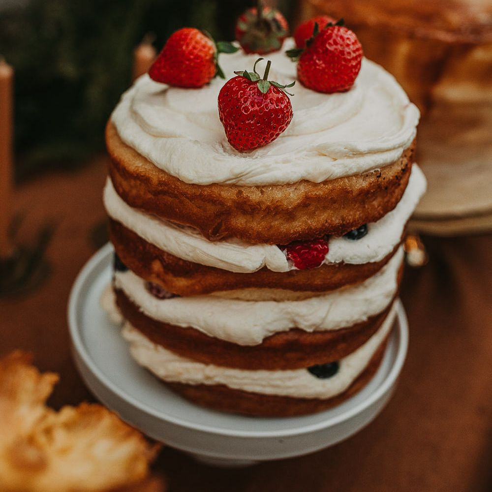 Stacked naked wedding cake with fruit topper 