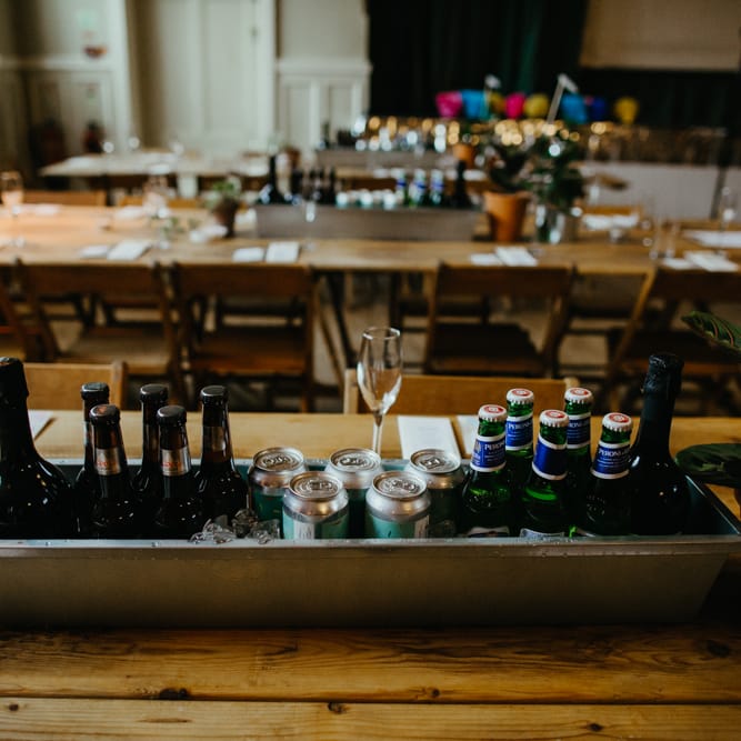 Trough of beer and wine as table centrepieces 