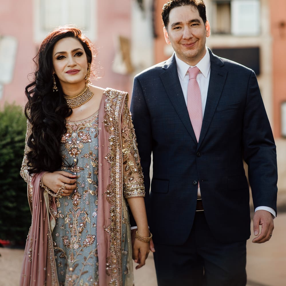 Bride & groom walk together as they hold hands