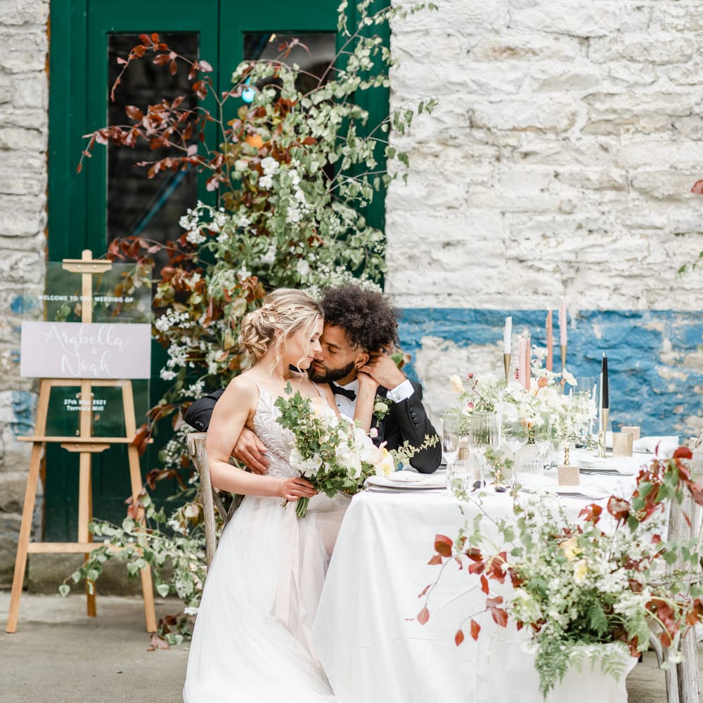 Bride and groom siting at their intimate wedding reception at Torr Vale Mill industrial wedding venue 