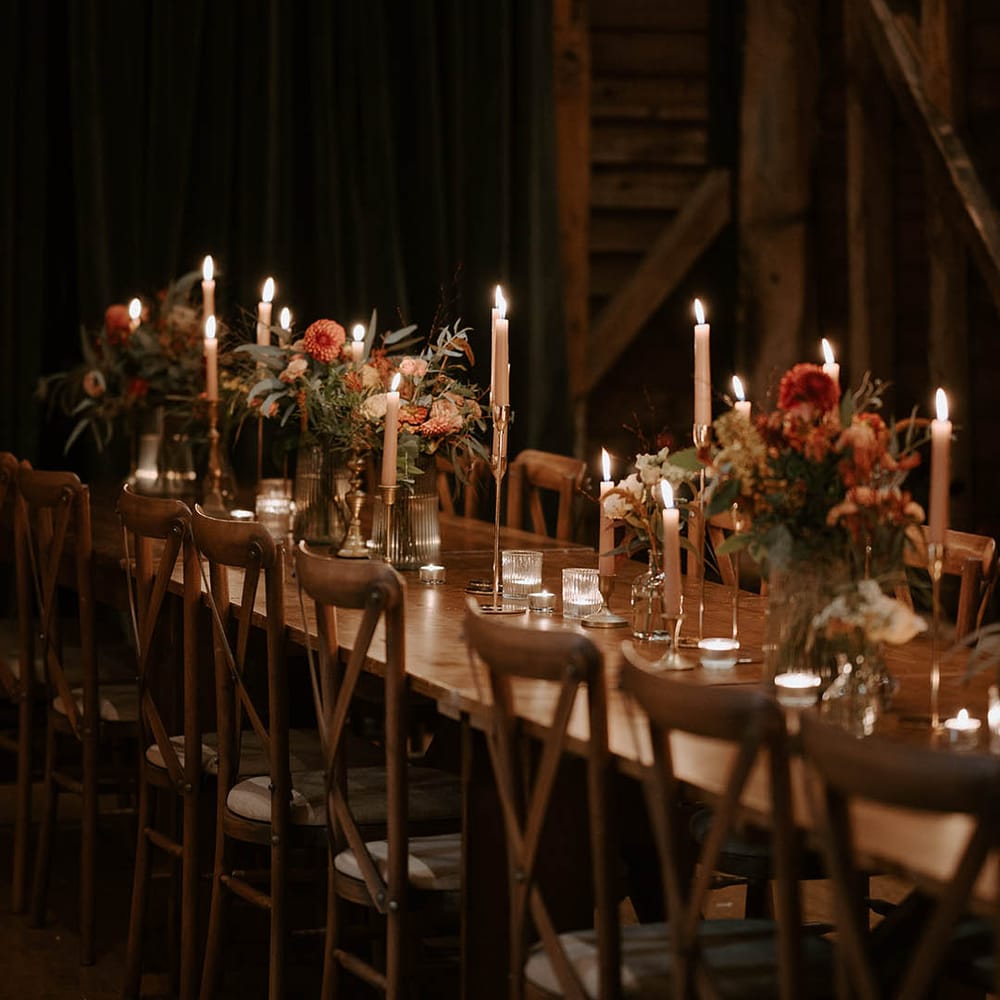 Candlelit wedding tables with flower centrepieces