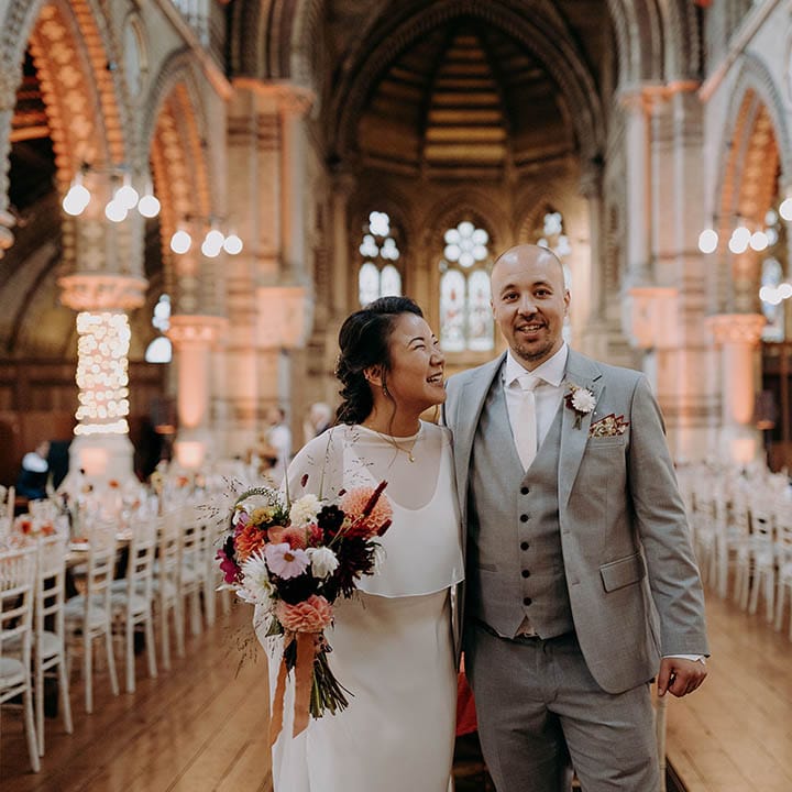 Bride looks lovingly at groom on their wedding day after ceremony