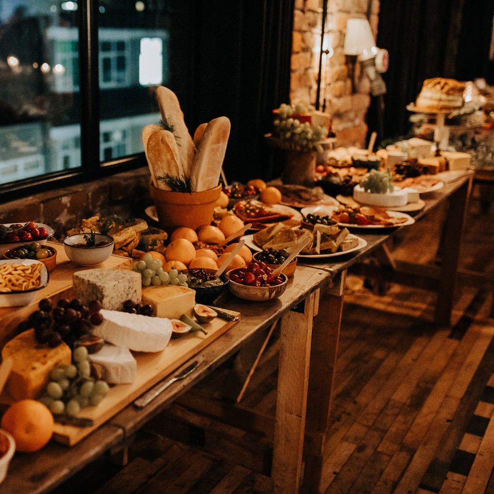 Large wedding grazing table with bread, olives and fruits for industrial rustic style wedding in Liverpool