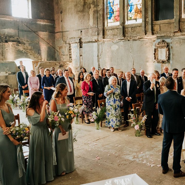 Bride and groom get married at Asylum Chapel wedding venue with stained glass windows