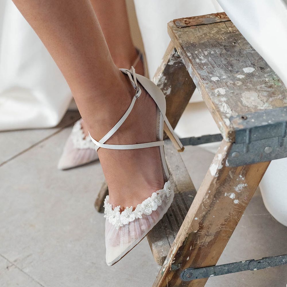 White stiletto wedding heels with ankle strap and sheer lace pointed to with flowers and beaded edge detail 