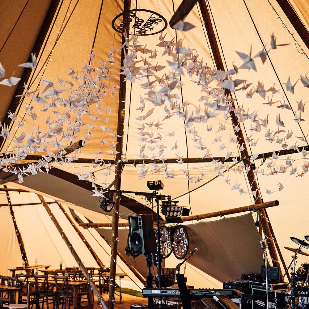 Paper crane wedding decor for tent reception and entertainment area