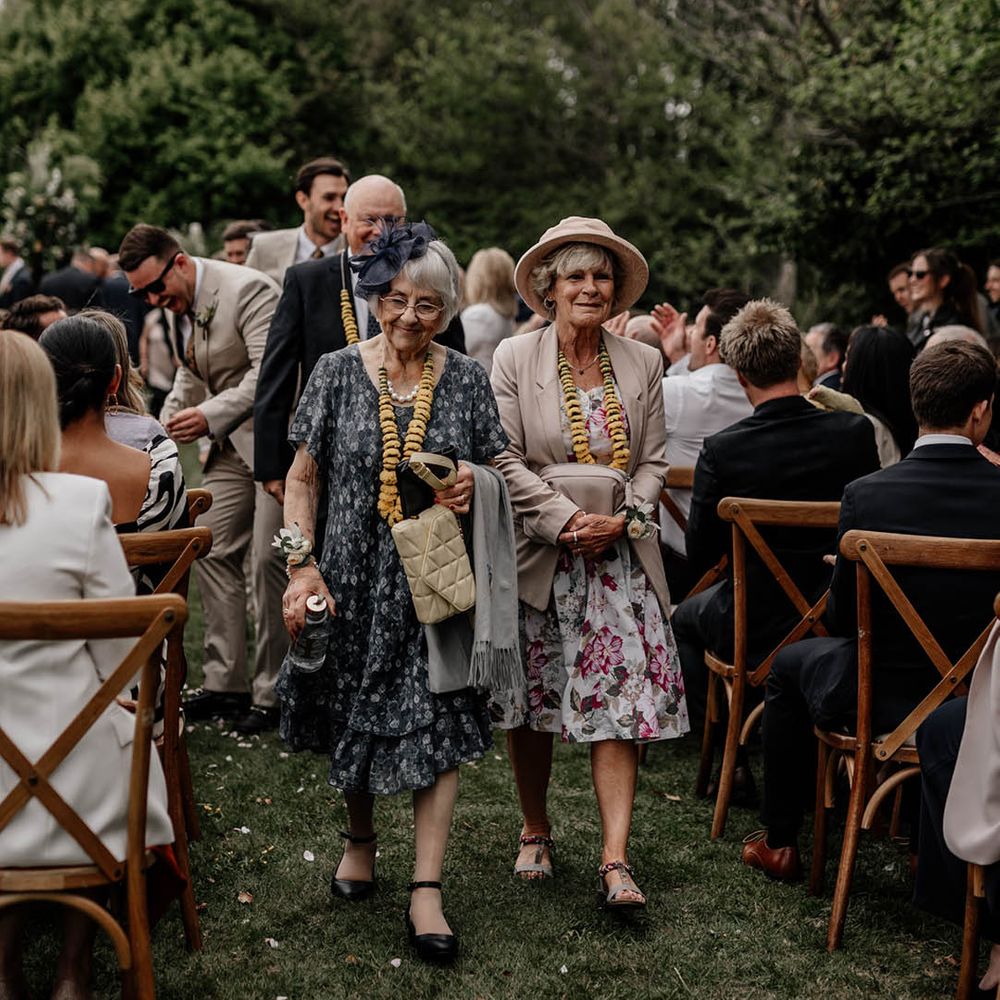 Family wearing yellow flower garlands after the Milni ceremony 