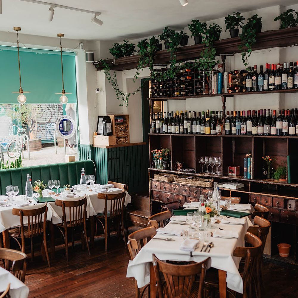 Restaurant reception dinner complete with green napkins and homegrown floral decor in rustic setting 