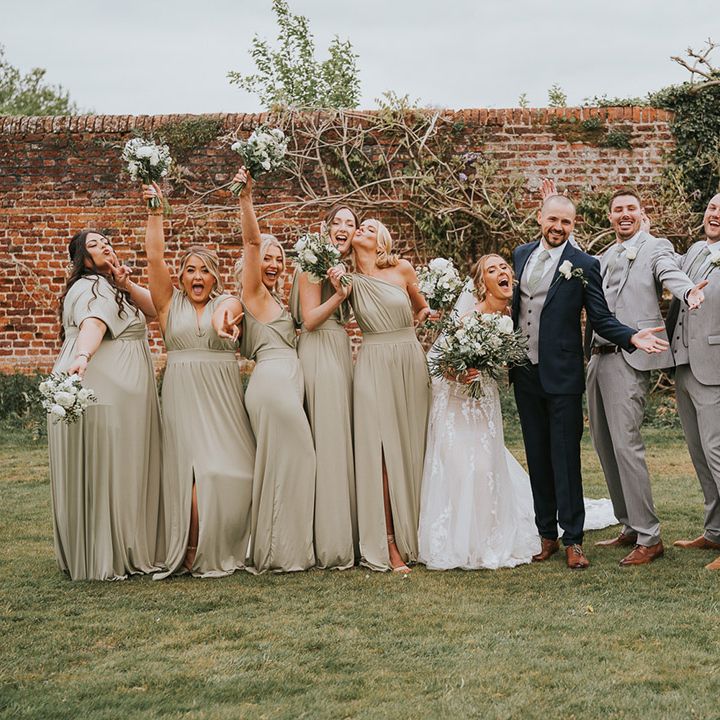 Bride and groom with the bridesmaids and groomsmen with classic and traditional buttonholes and bouquets 