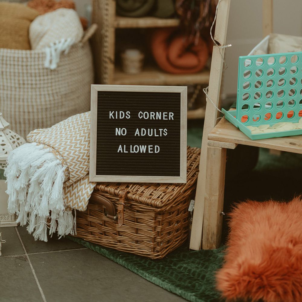Peg board sign for the kid's station with blankets, pillows, and fun activities 