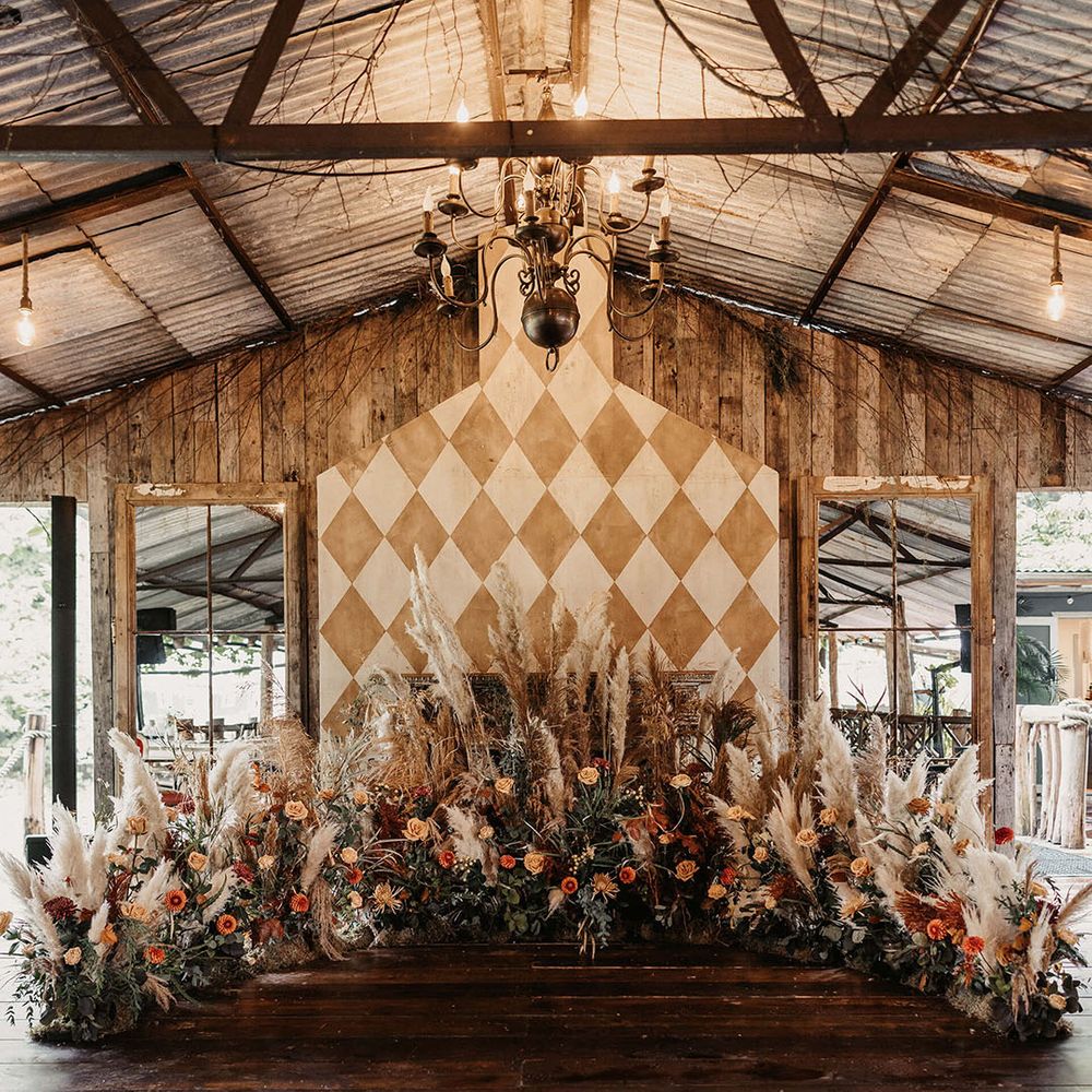 Dried floral Autumnal arrangement with pampas grass to the front of aisle 