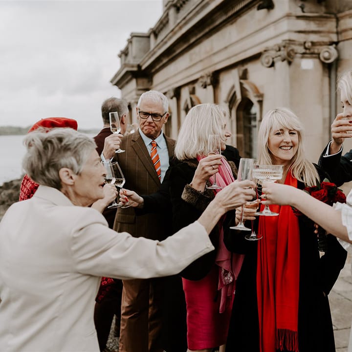 The bride shares a toast with her wedding guests and drink champagne together to celebrate the day
