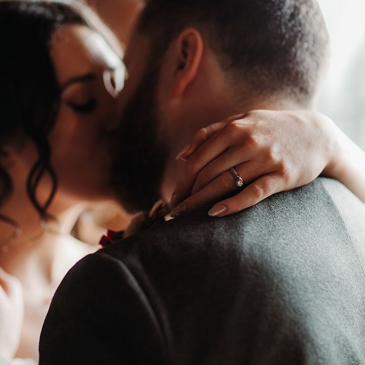 Bride with chrome wedding nails with round diamond engagement ring and diamond wedding band 