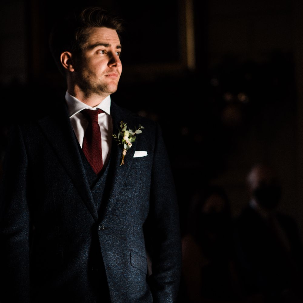 Groom waits for bride during ceremony