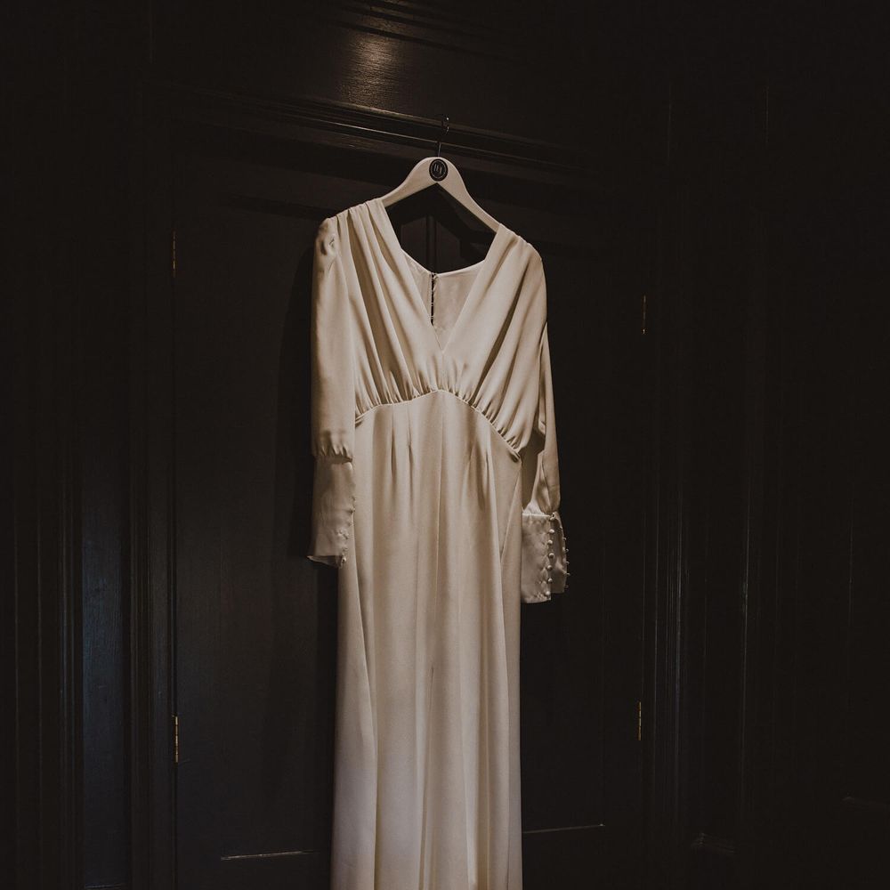 Long sleeved silk bridal gown with buttoned sleeves