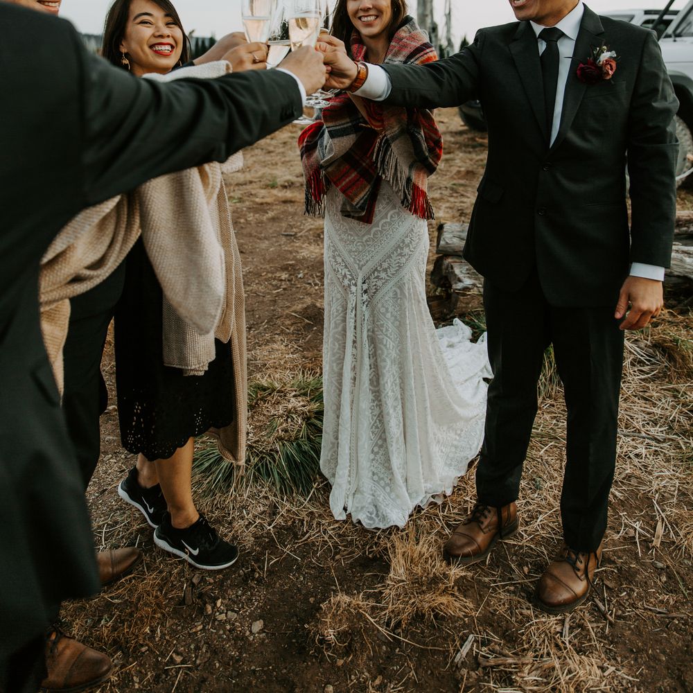 Bride & groom celebrate with champagne and wedding guests