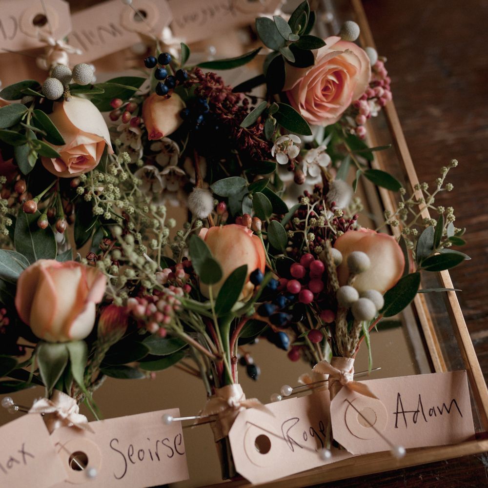 Peach, pink and white wedding pocket flowers and name tags